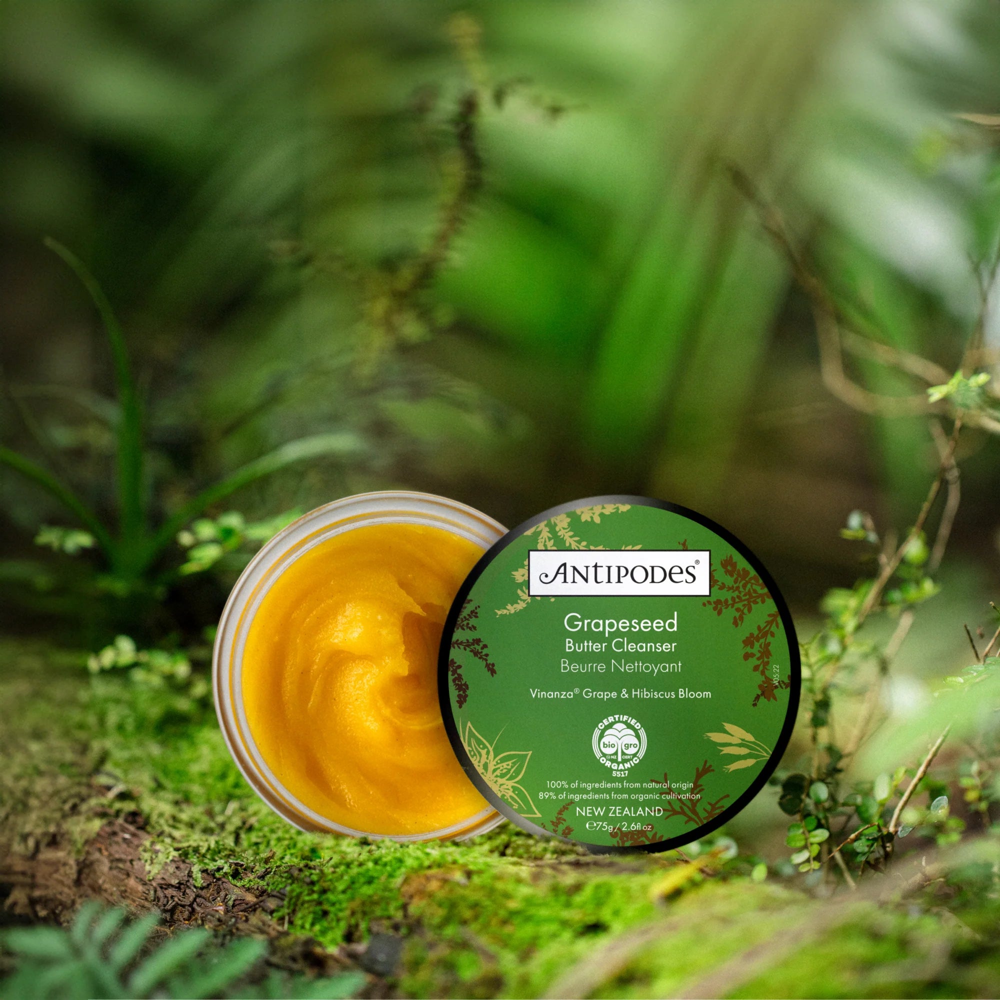 Antipodes Grapeseed Butter Cleanser with green label on a natural background