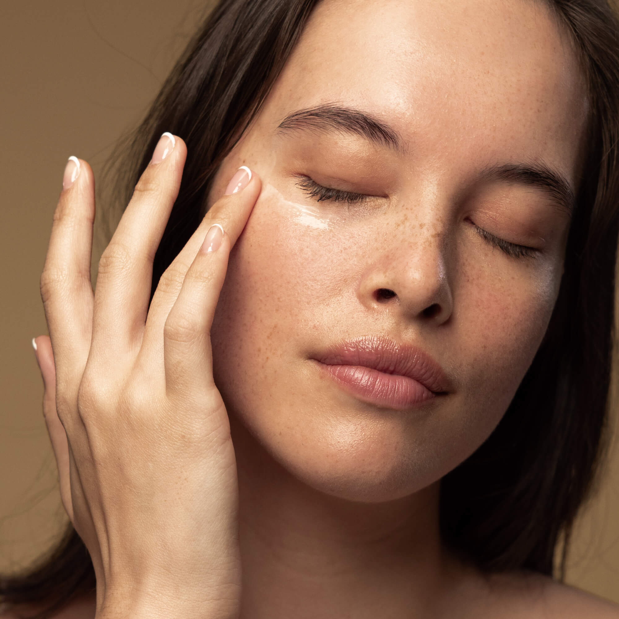 Antipodes kiwiseed oil eye cream on woman's face