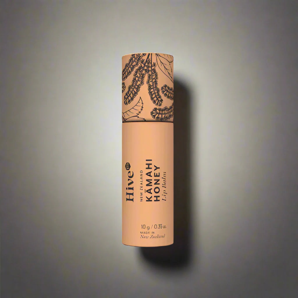 Hive Kamahi lip balm tube on a gray background