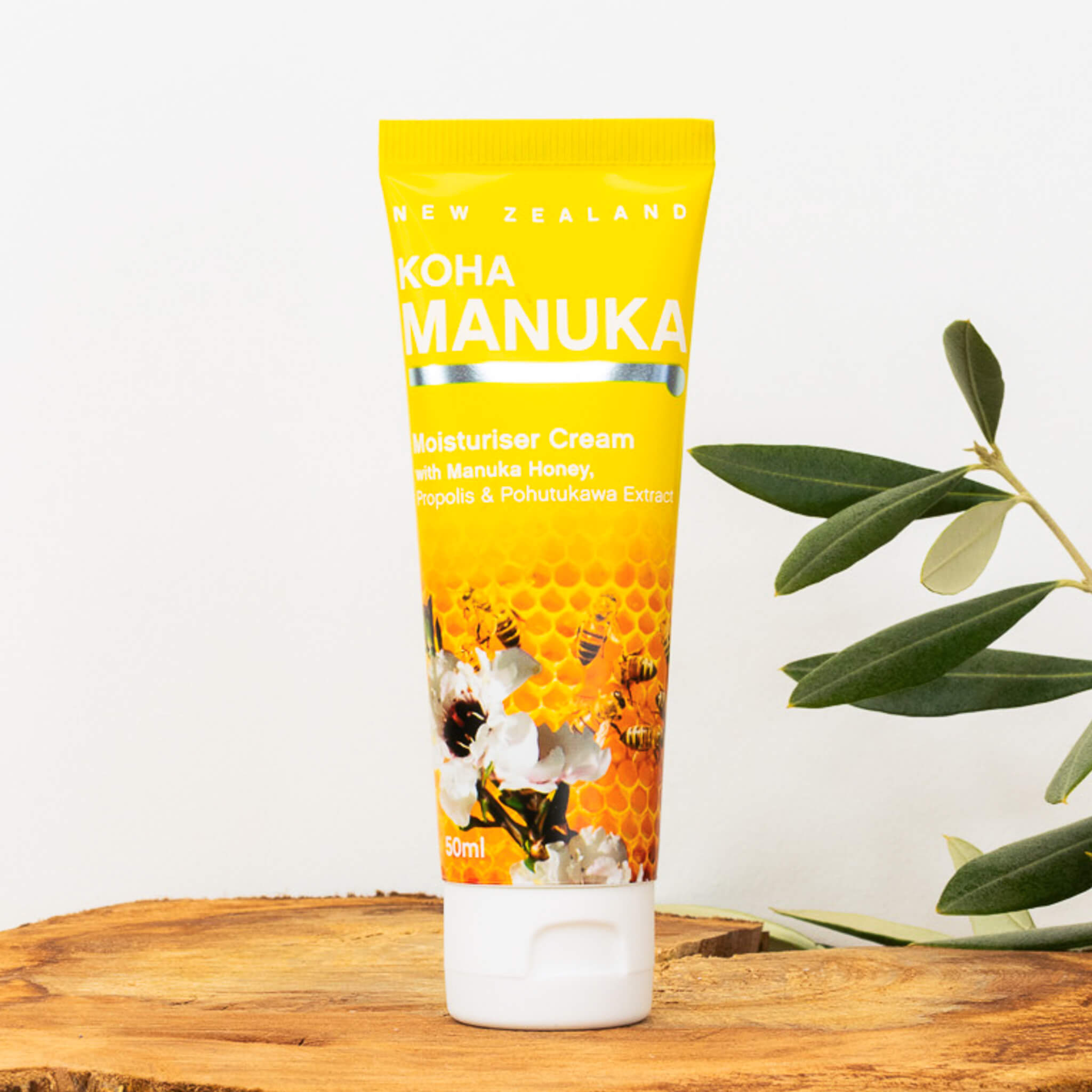 Koha manuka moisture cream on wooden tatable with plant behind