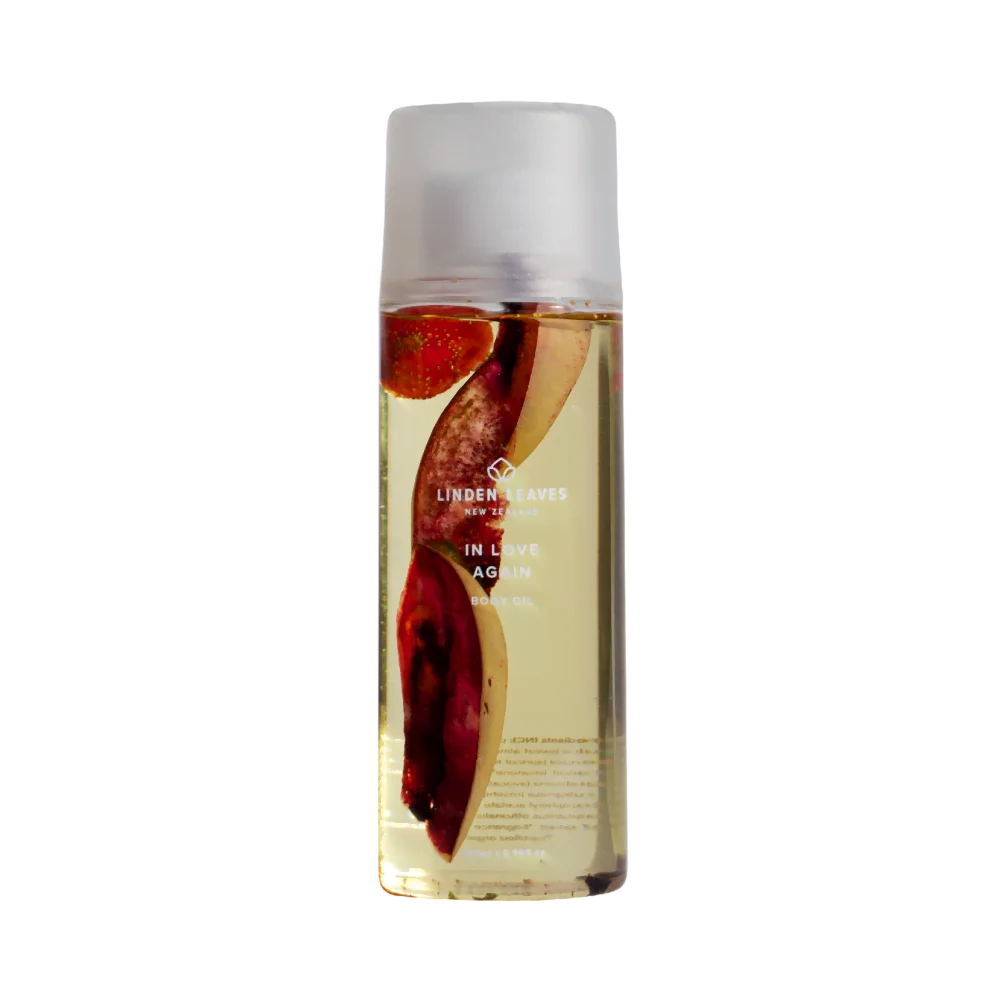 Bottle of Linden Leaves in love again body oil with a white cap on a white background