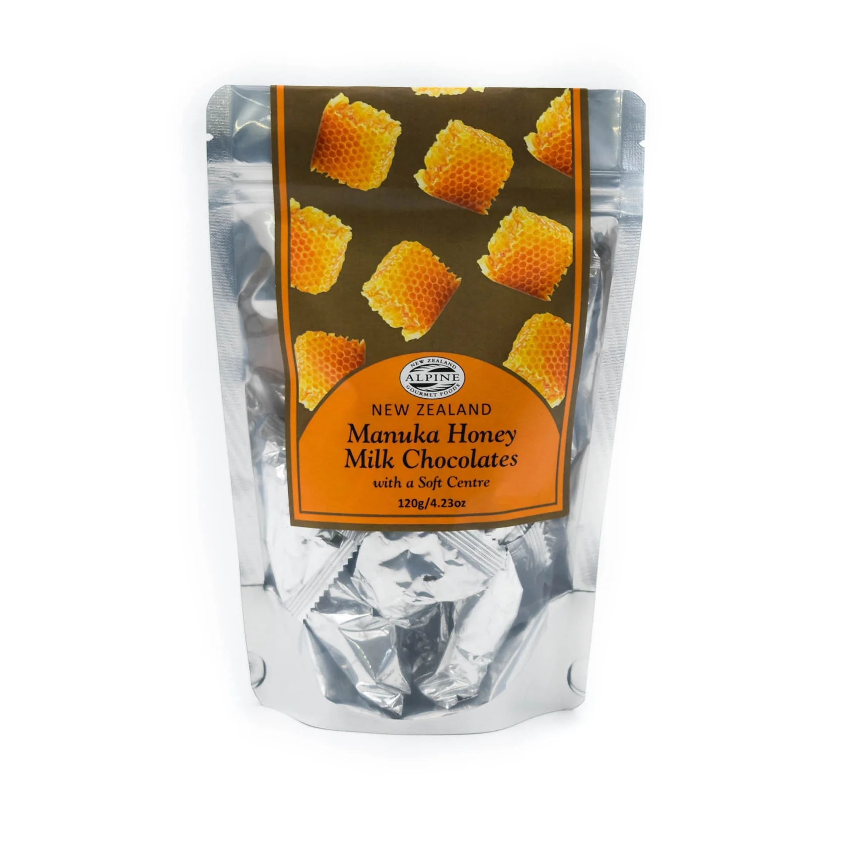 A silver stand-up pouch of Kauri Manuka Honey Milk Chocolates with soft centers, featuring a brown label with honeycomb illustrations on a white background.