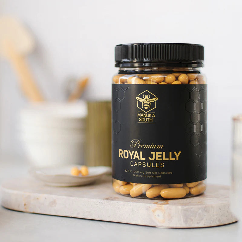 Jar of Manuka South Premium Royal Jelly Capsules on a marble surface with a blurred background