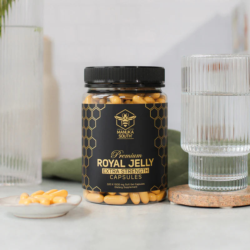 Jar of Manuka South Royal Jelly extra strength 320 capsules on a white surface with decorative elements.