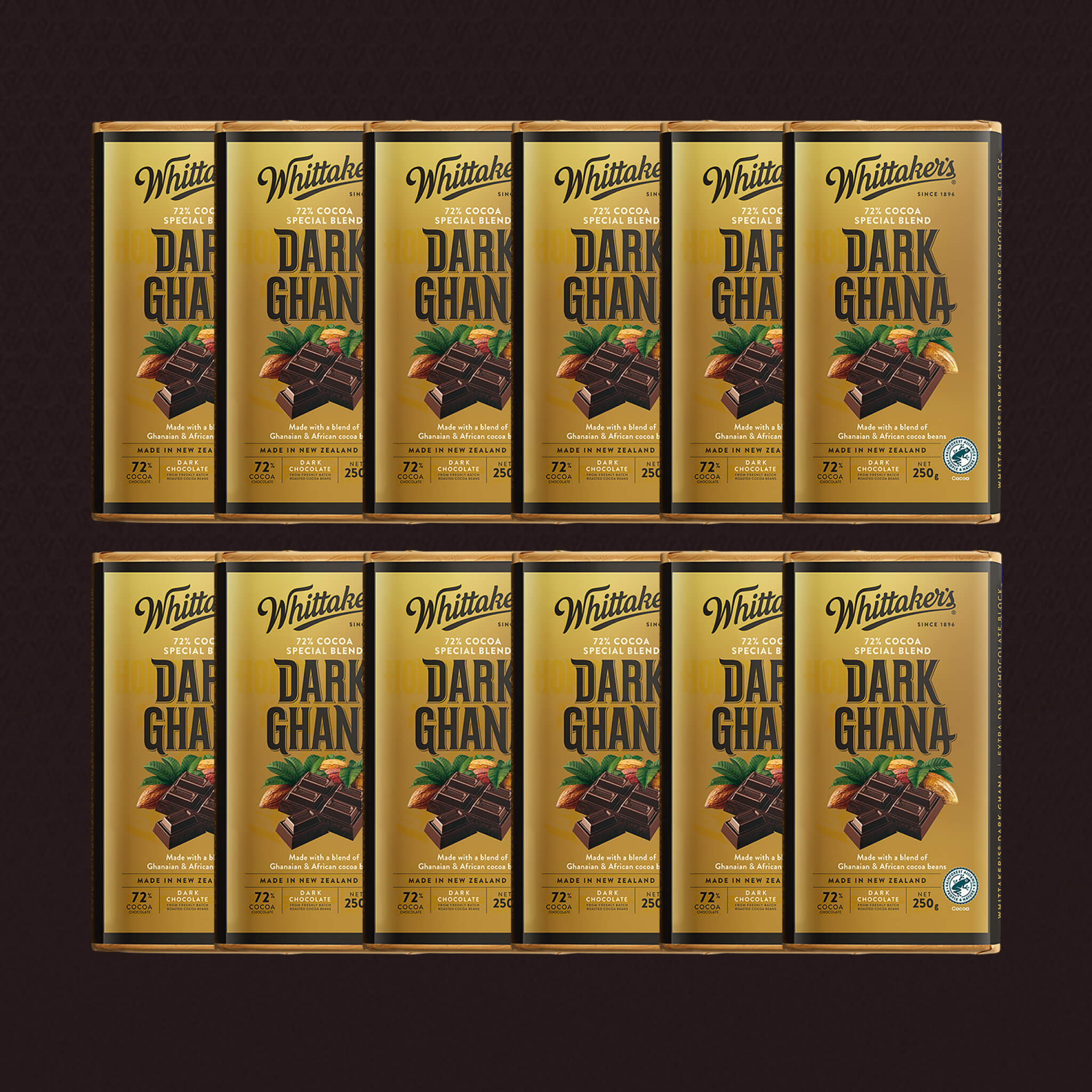 Multiple boxes of Whittaker's Dark Ghana chocolate on a dark background