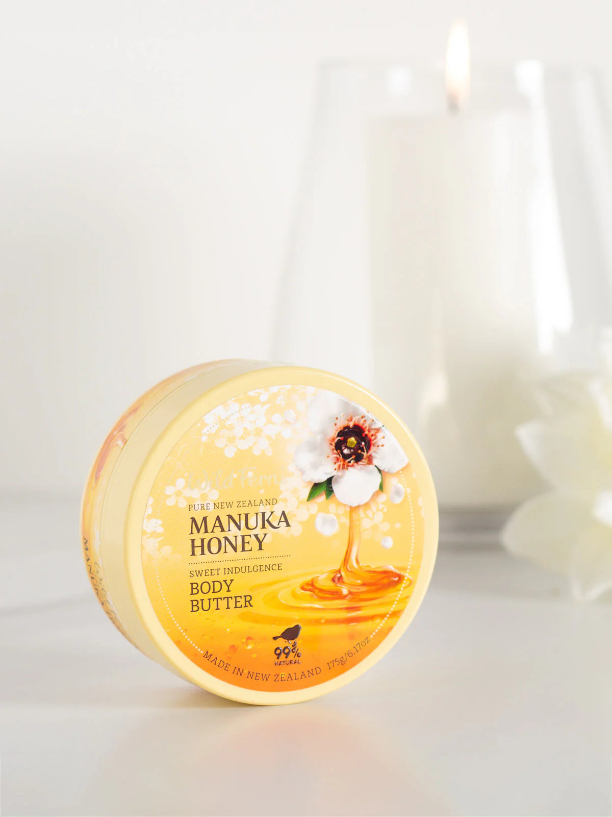 Wild Fern's Manuka Honey body butter container with a floral design on a white background