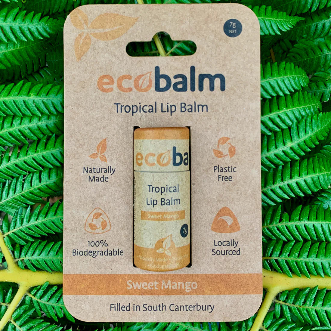 ecobase ecobalm tropical lip balm packaging on a green leaf background