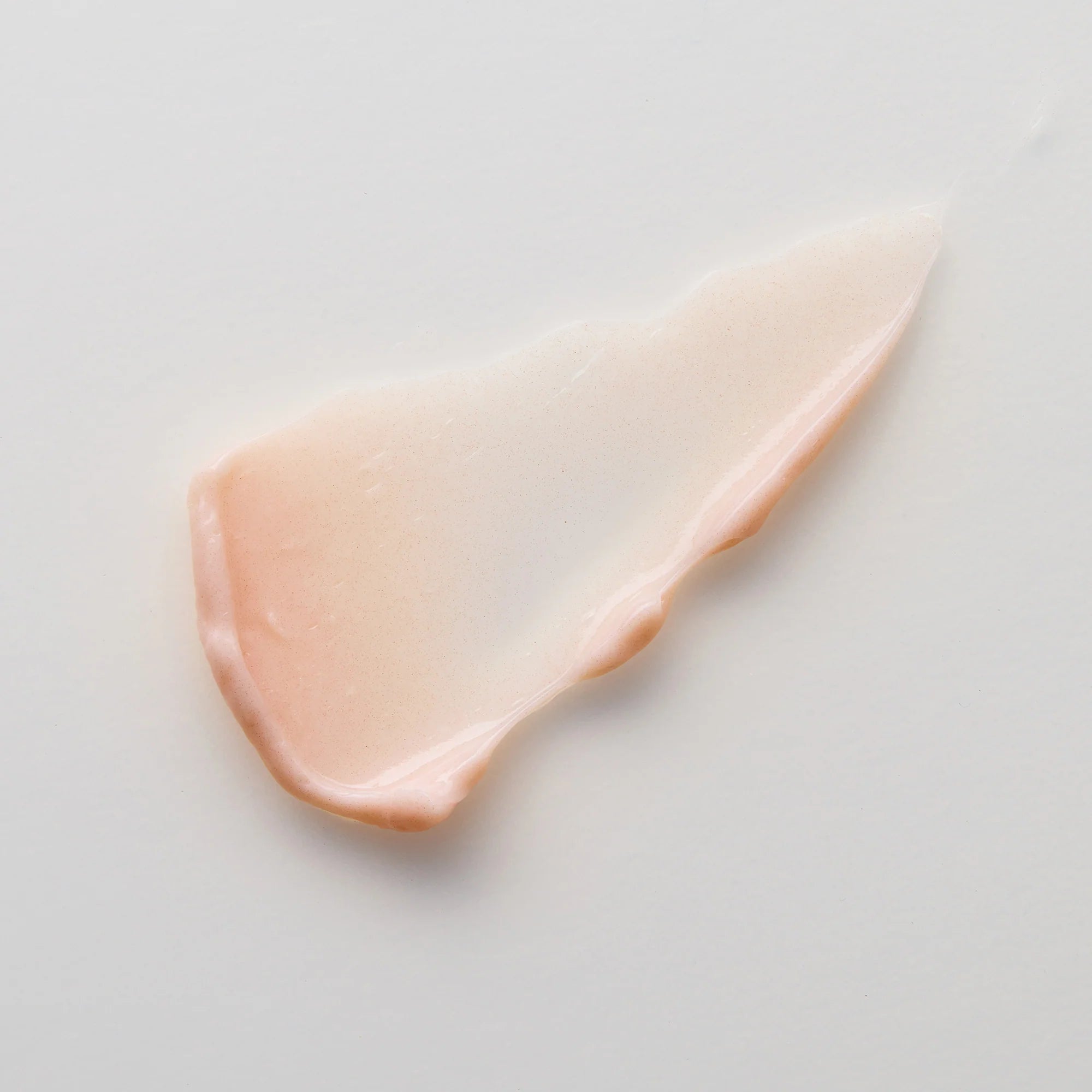 Close-up of a beige cream of Antipodes Flora on a light gray background