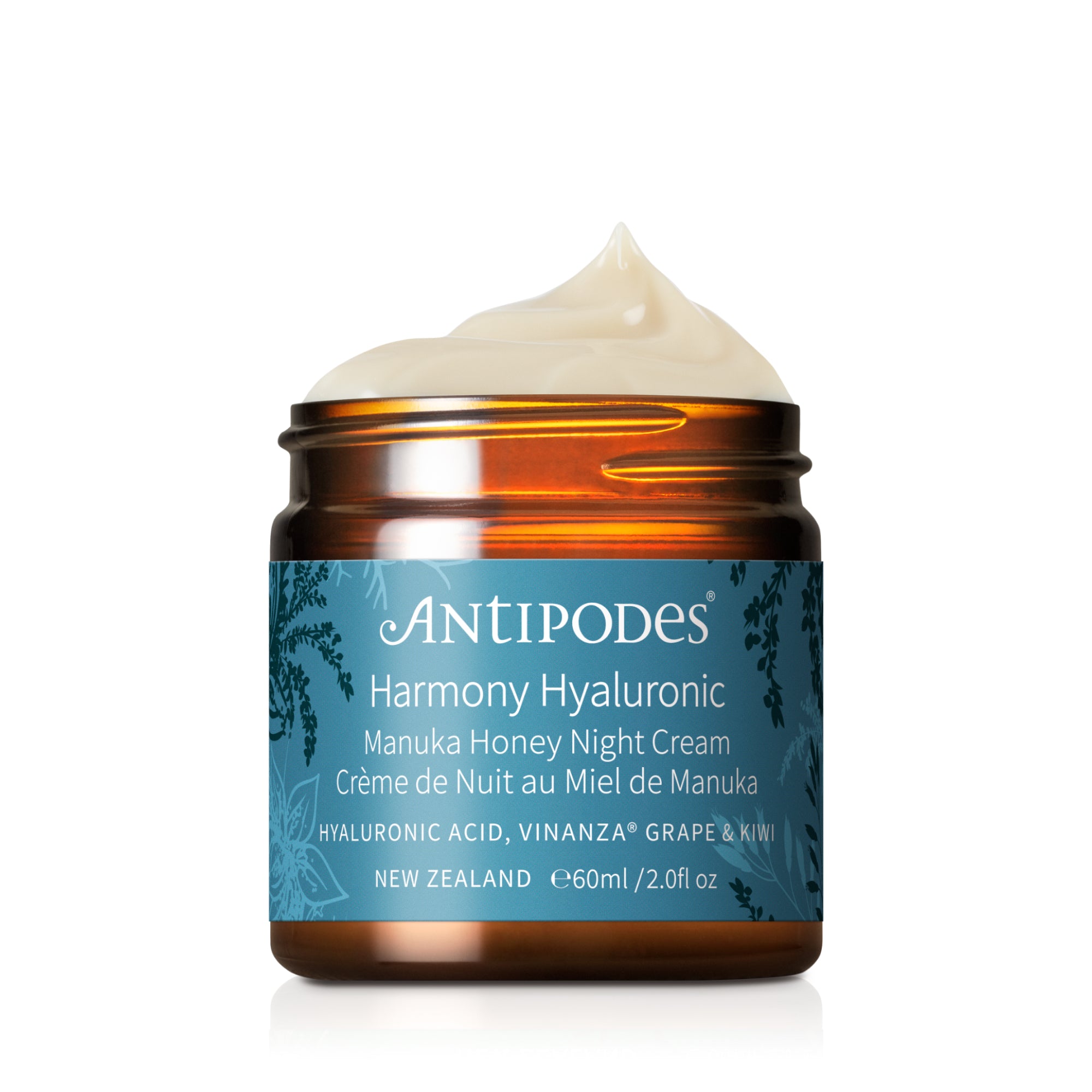 Antipodes Harmony Hyaluronic Manuka Honey Night Cream in a jar with a blue label, featuring honey and grapefruit illustrations, and text indicating the product is made in New Zealand.
