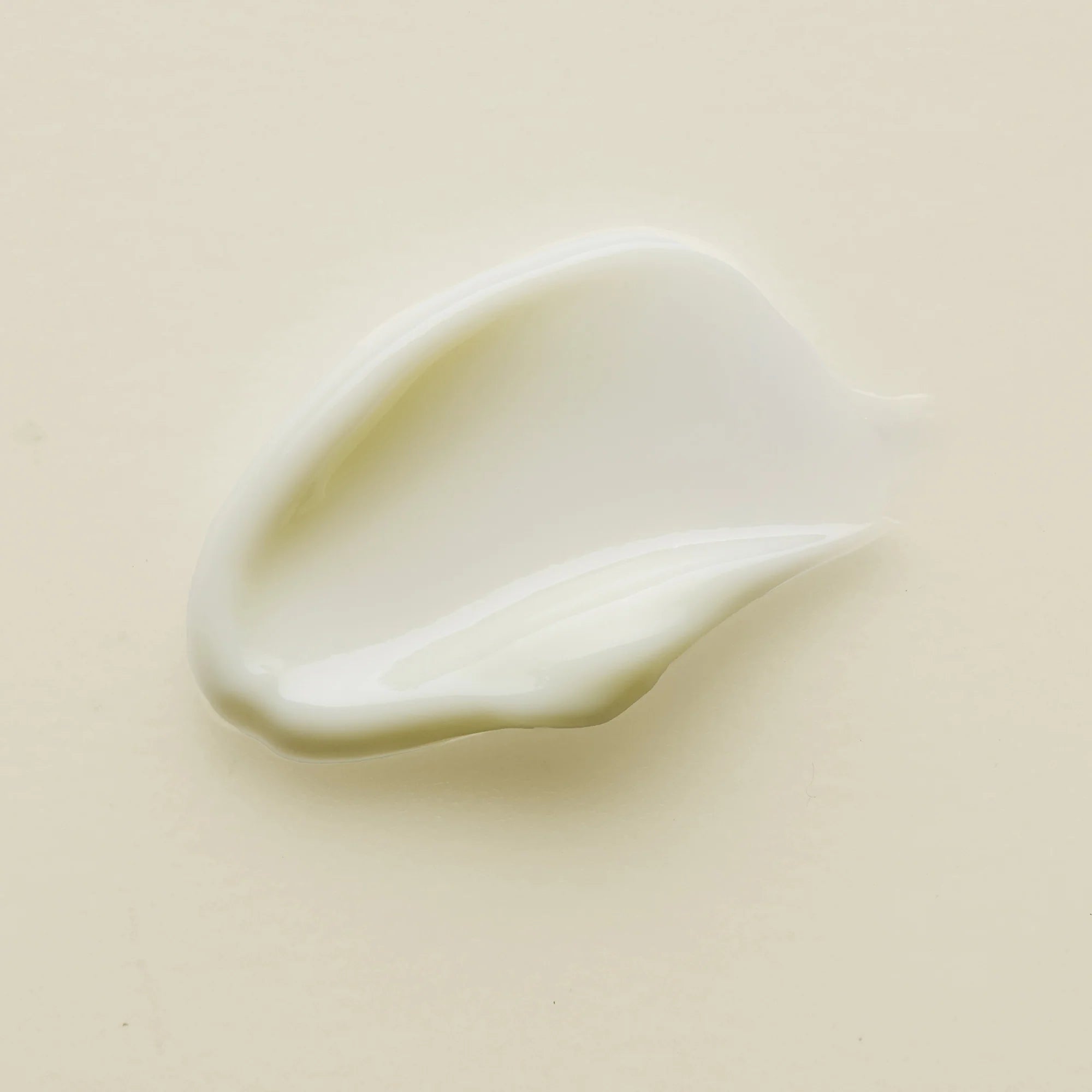 Close-up of a smooth, light-colored cream of Antipodes kiwi seed oil