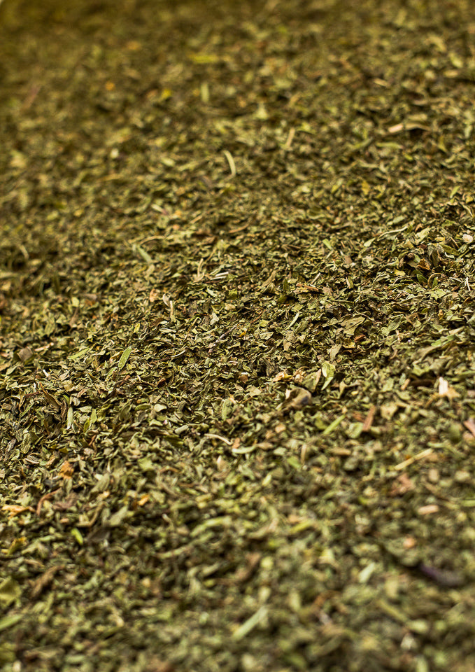 A close-up, top-down view of a dried manuka mint tea blend, Kerikeri Organic Tea.