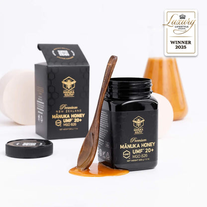 Manuka South Manuka honey UMF 20+ 250g  jar with wooden spoon and packaging on a white background, featuring a 'Luxury Lifestyle Award' badge.