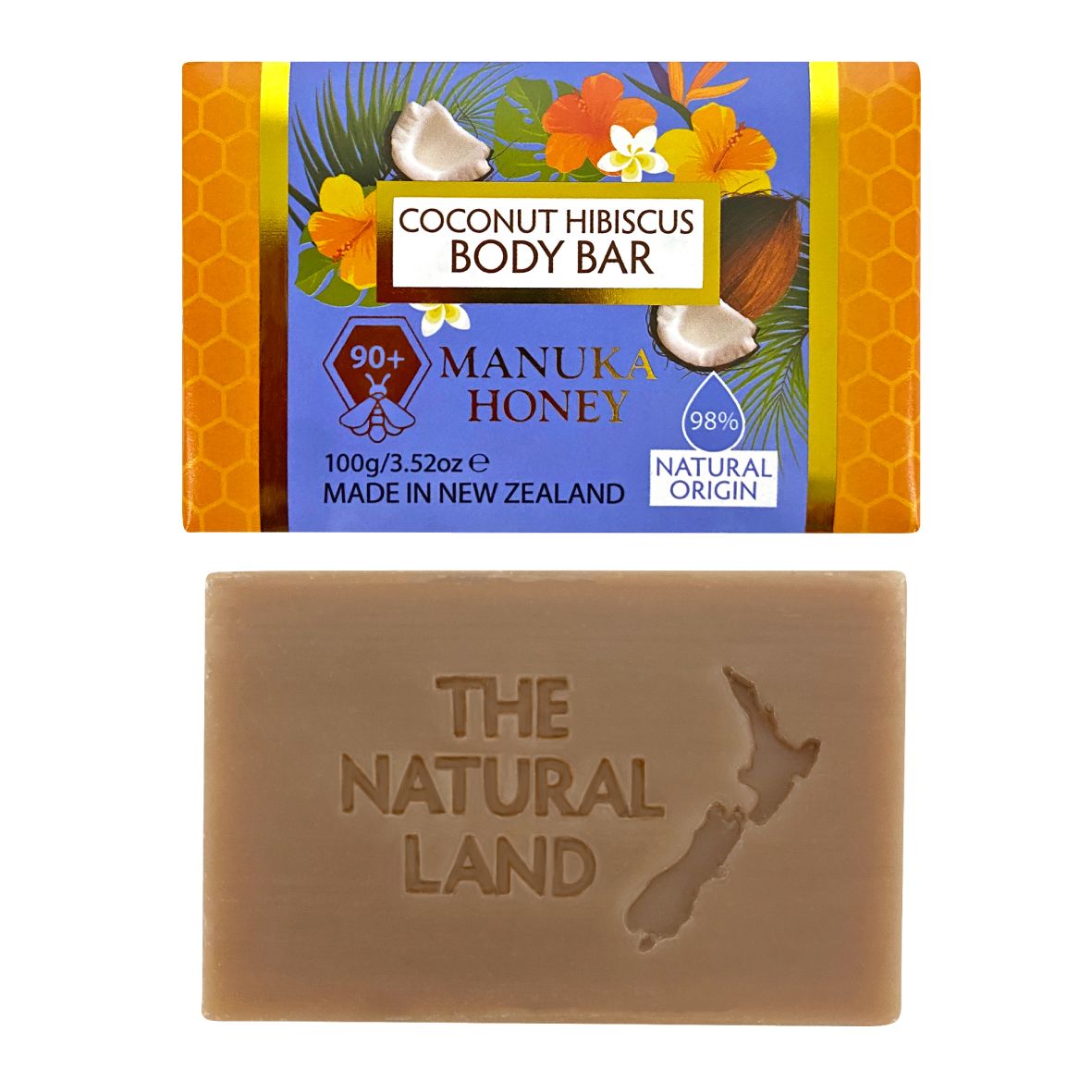 Two body bars shown on a plain white background: a packaged bar labeled 'Coconut Hibiscus Body Bar' with tropical fruit and honey graphics, and an unwrapped tan rectangular bar embossed with 'THE NATURAL LAND' and a New Zealand map shape. Visible product branding includes 'The Natural Land' on the unwrapped bar and 'Coconut Hibiscus Body Bar' / 'Manuka Honey' on the package.