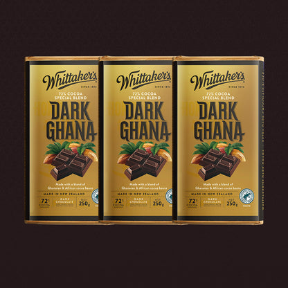 Three packages of Whittaker's Dark Ghana chocolate on a dark background
