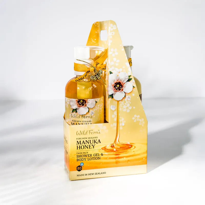 Manuka Honey shower gel and body lotion set with packaging on a white background