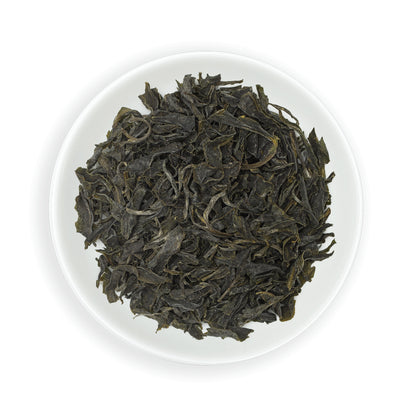 Zealong Tea dry green tea leaves on a white plate