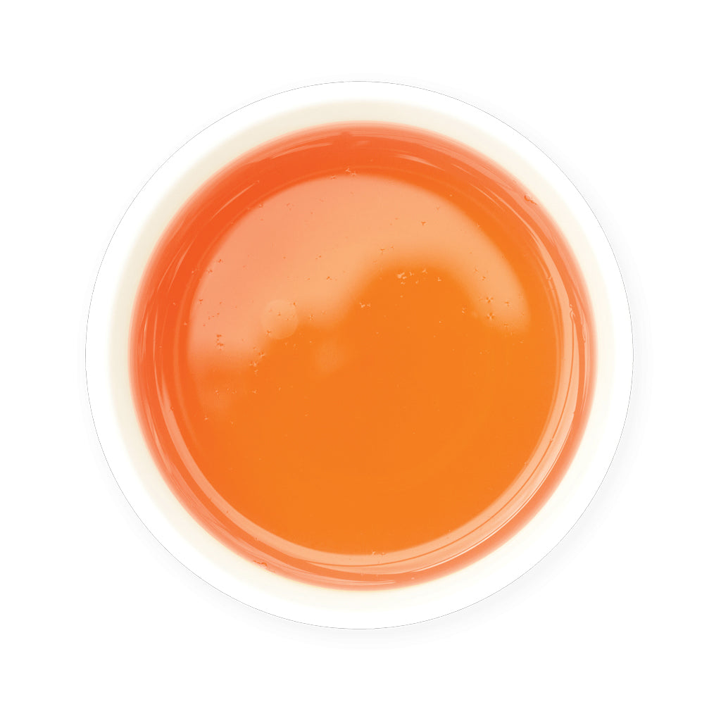 Zealaong tea in a small container on a white background