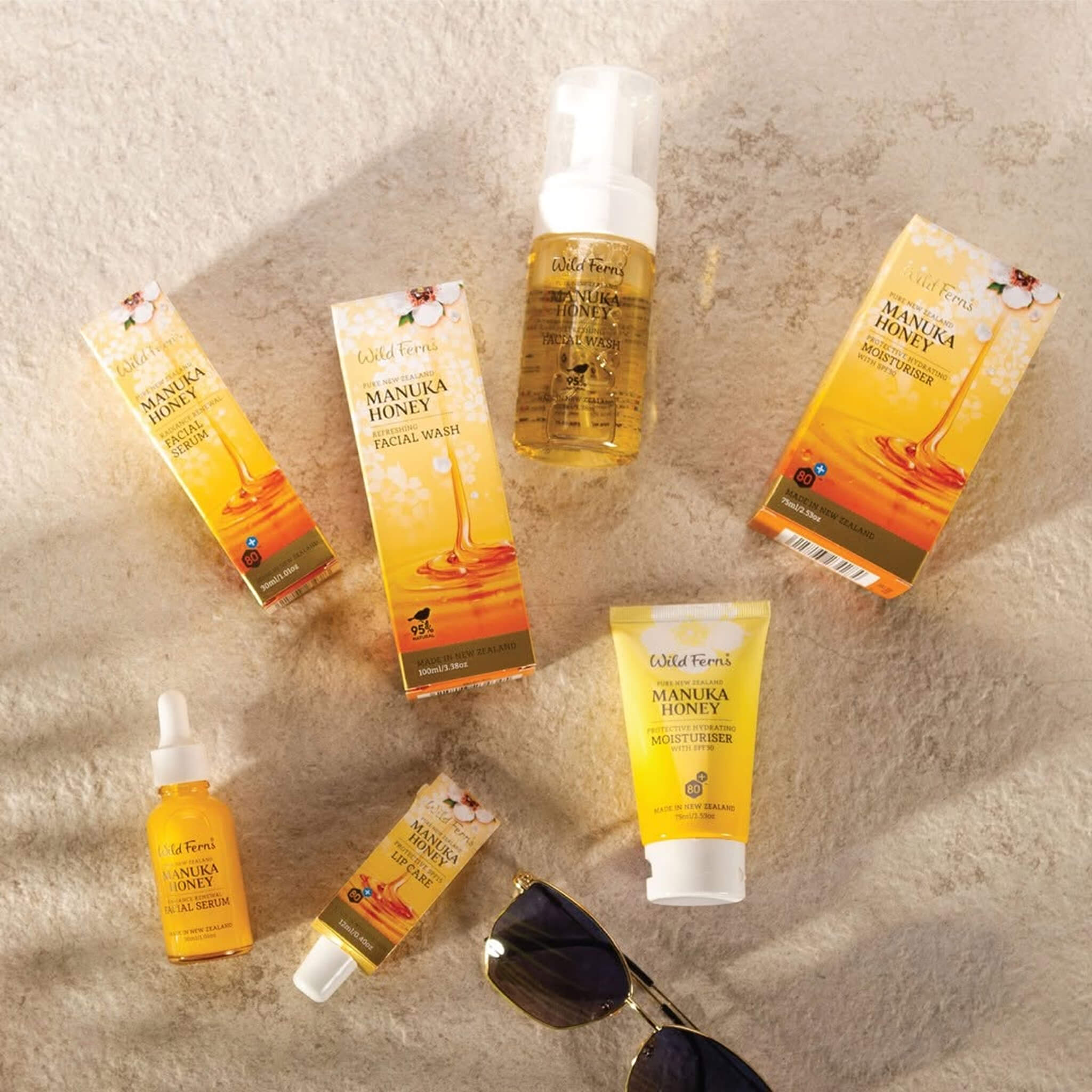 Wild Ferns Manuka Honey skincare products on a textured beige background